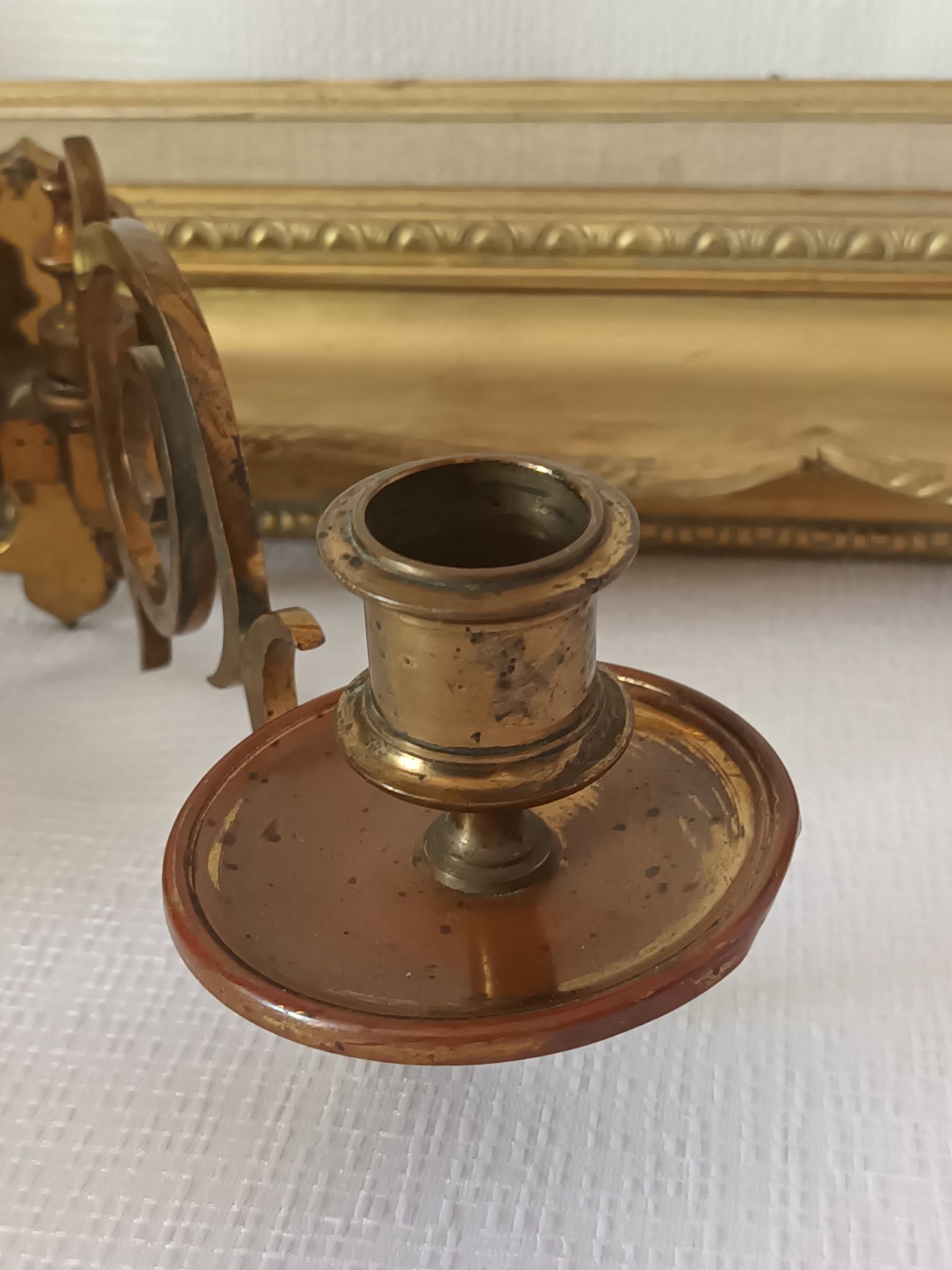 Pair of antique wall-mounted brass candle holders