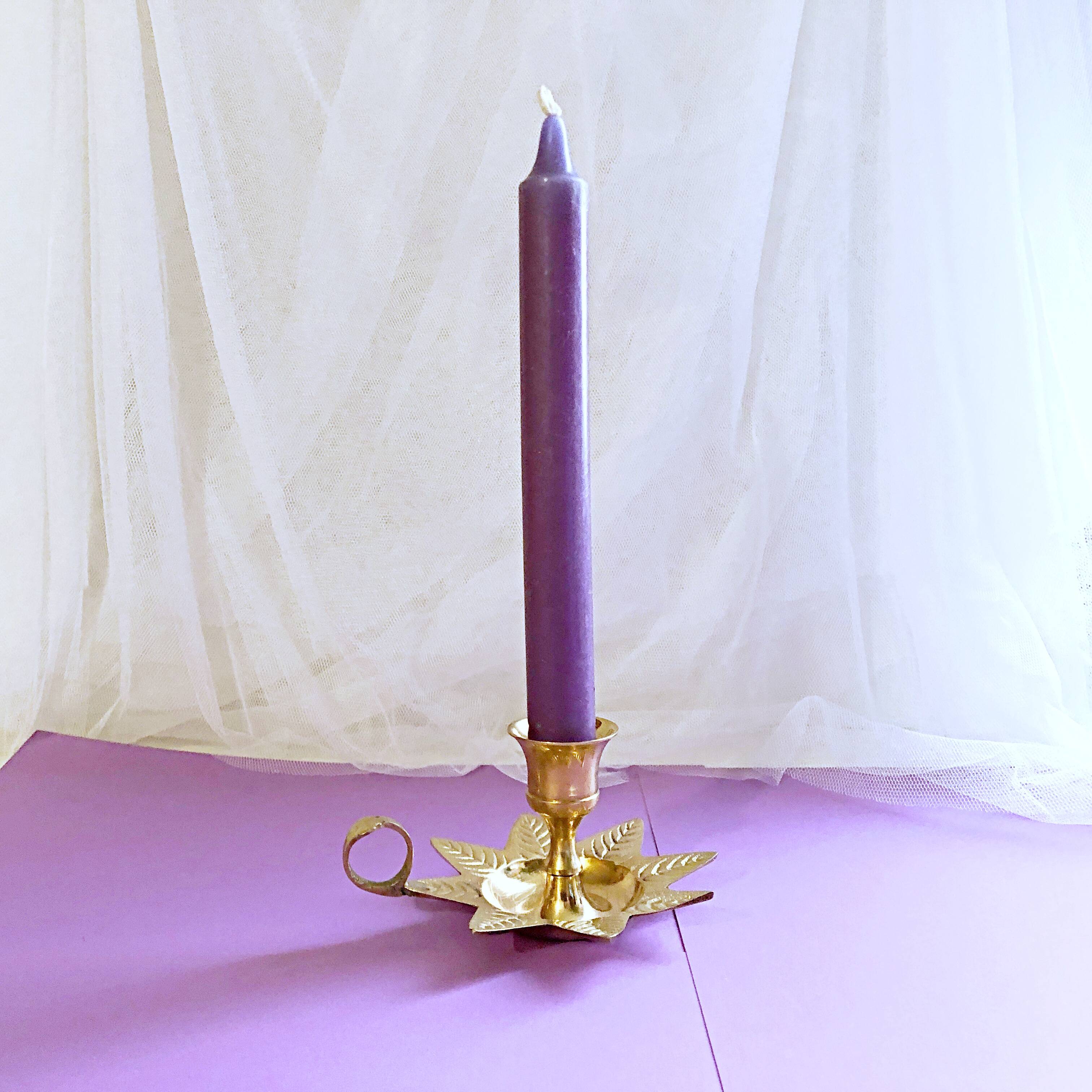 Golden brass hand candle holder decorated with leaves