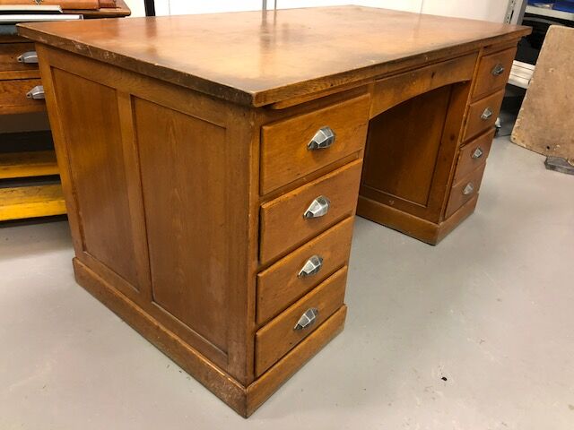 Old wooden desk has double subwoofer
