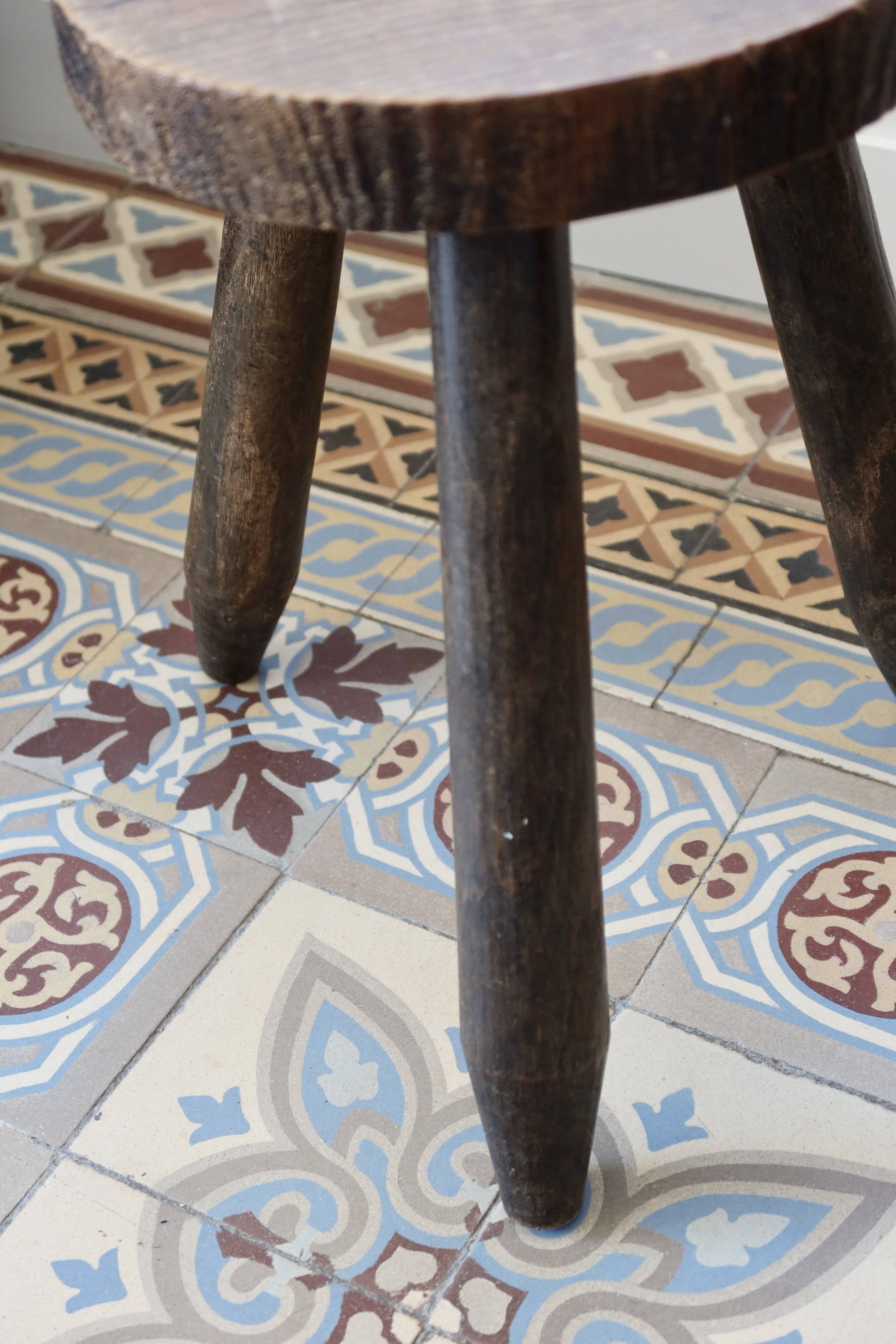 Old dark wood tripod stool