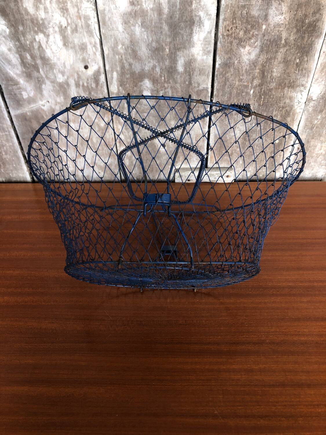 Old foldable blue metal basket, vintage handles