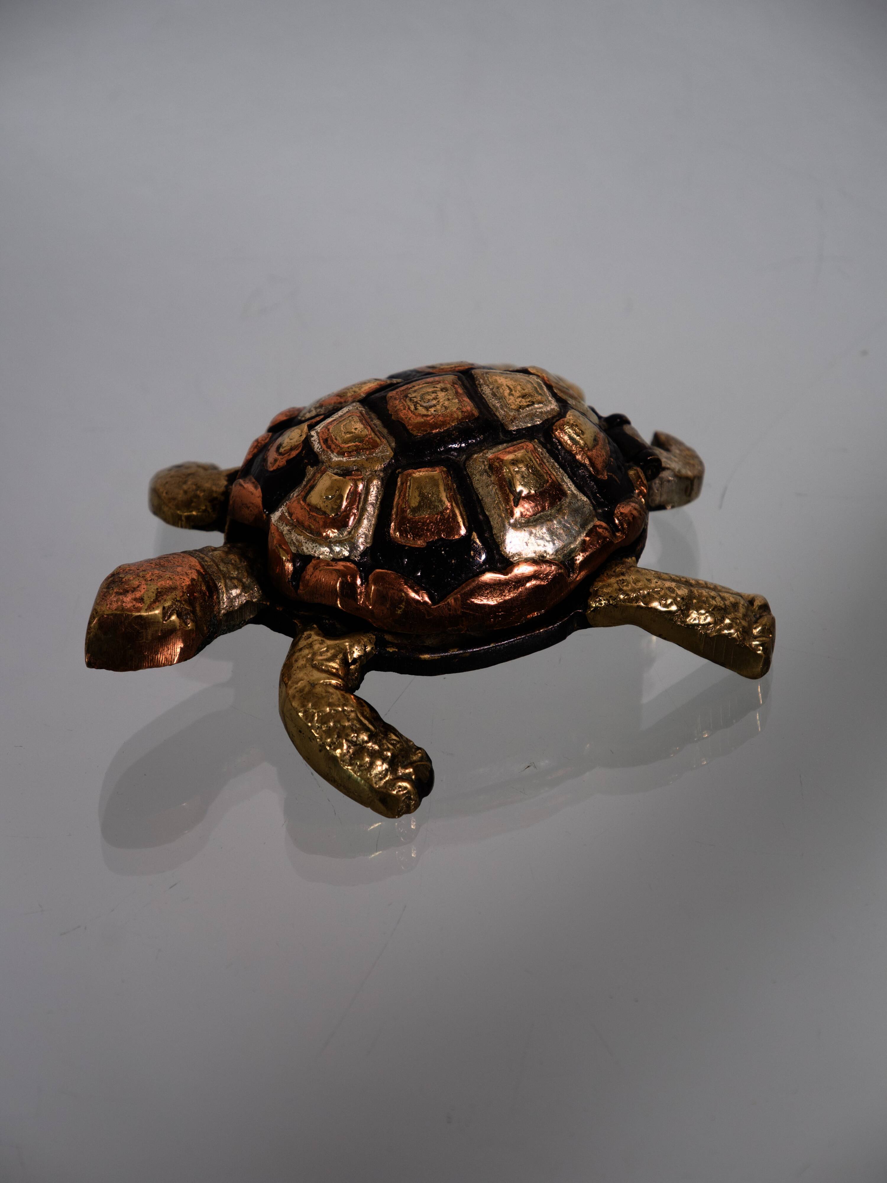 Golden brass turtle in decorative ashtray
