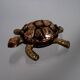Golden brass turtle in decorative ashtray