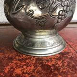 Tin pitcher decorating bunch of grapes