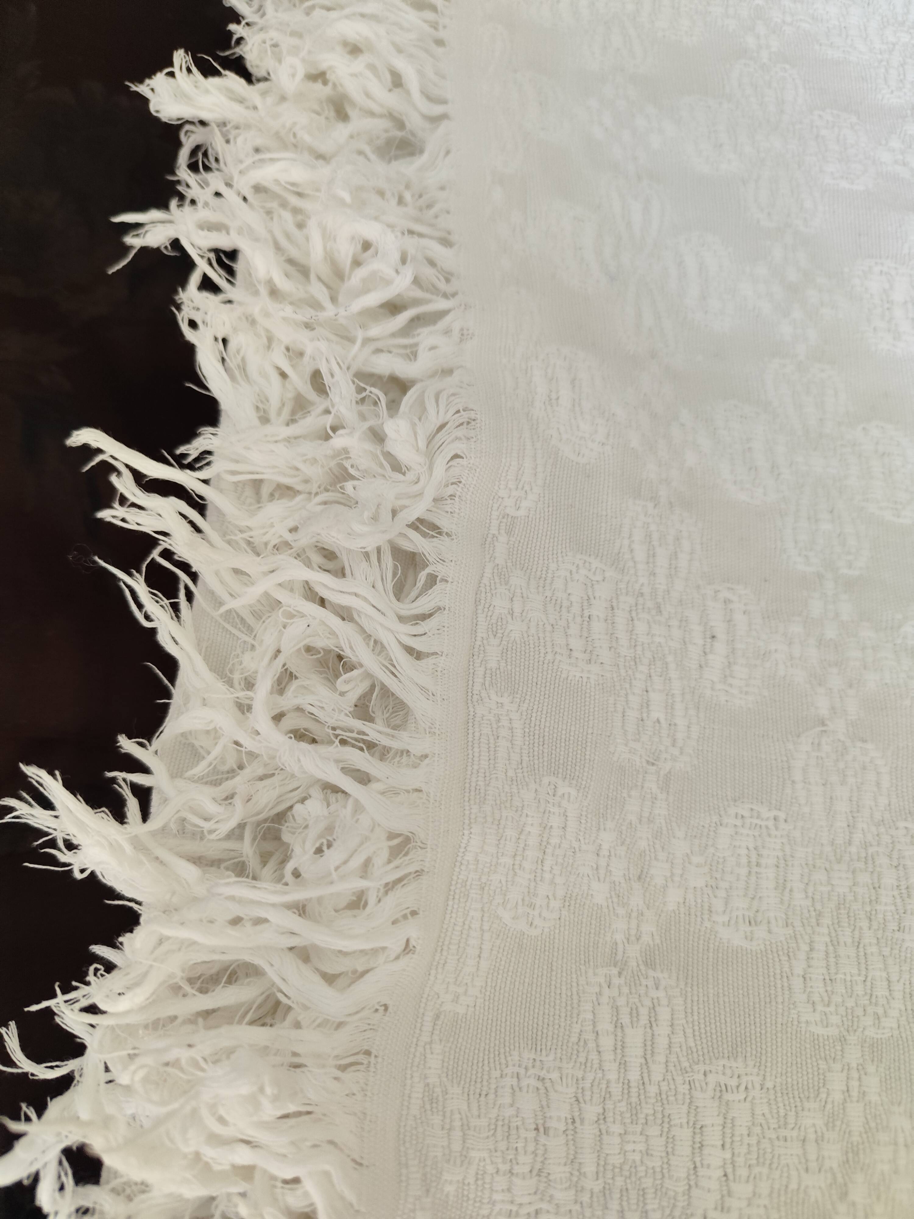 White woven cotton bedspread with fringes