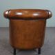 Club armchair in sheepskin with black piping
