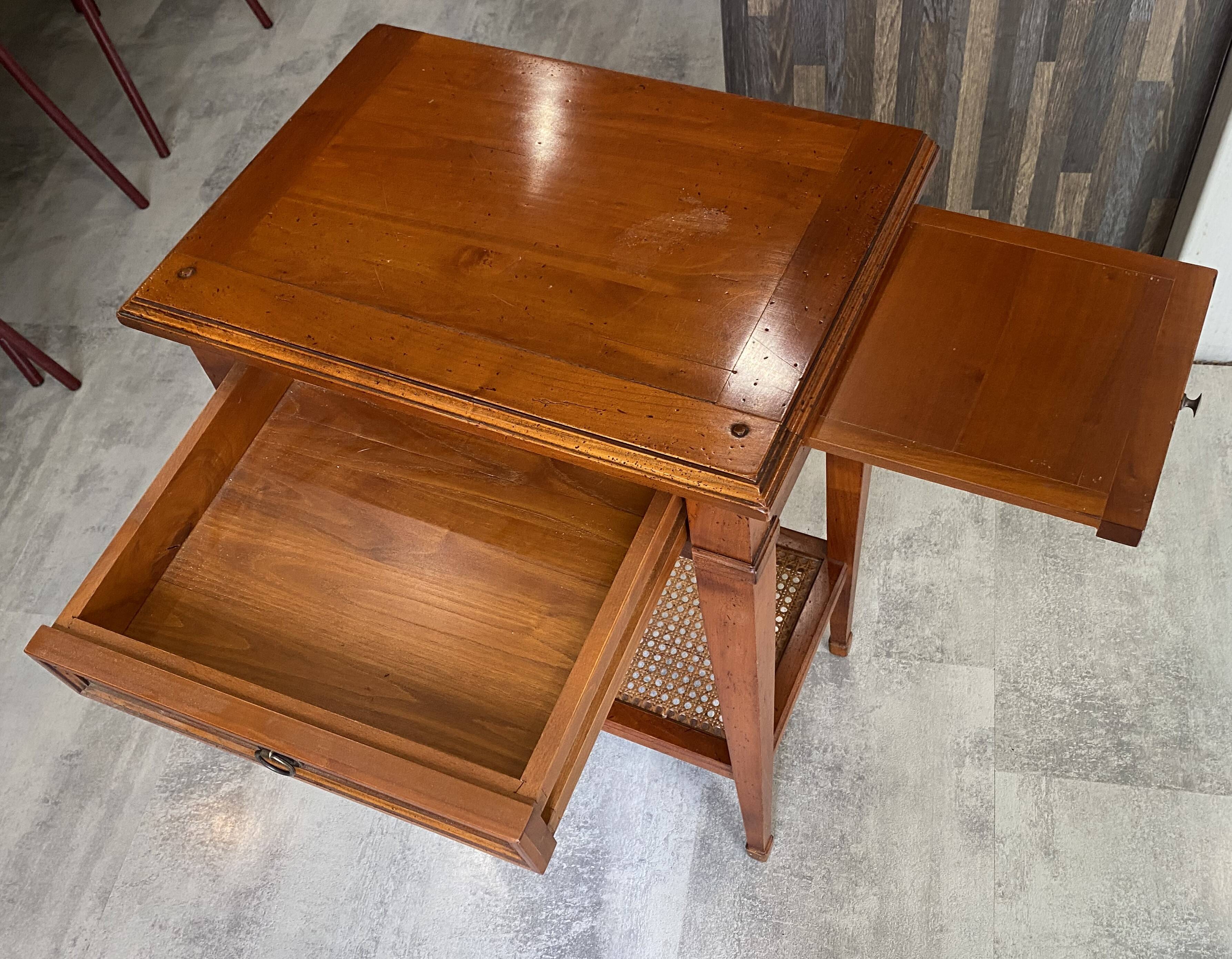 Occasional table in cherry wood, 1 drawer, 1 cane shelf, 1950.