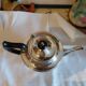 Old English teapot in silver-plated metal and Bakelite.