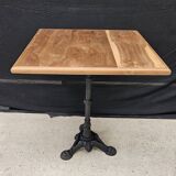 Bistro table with cast iron base and teak top