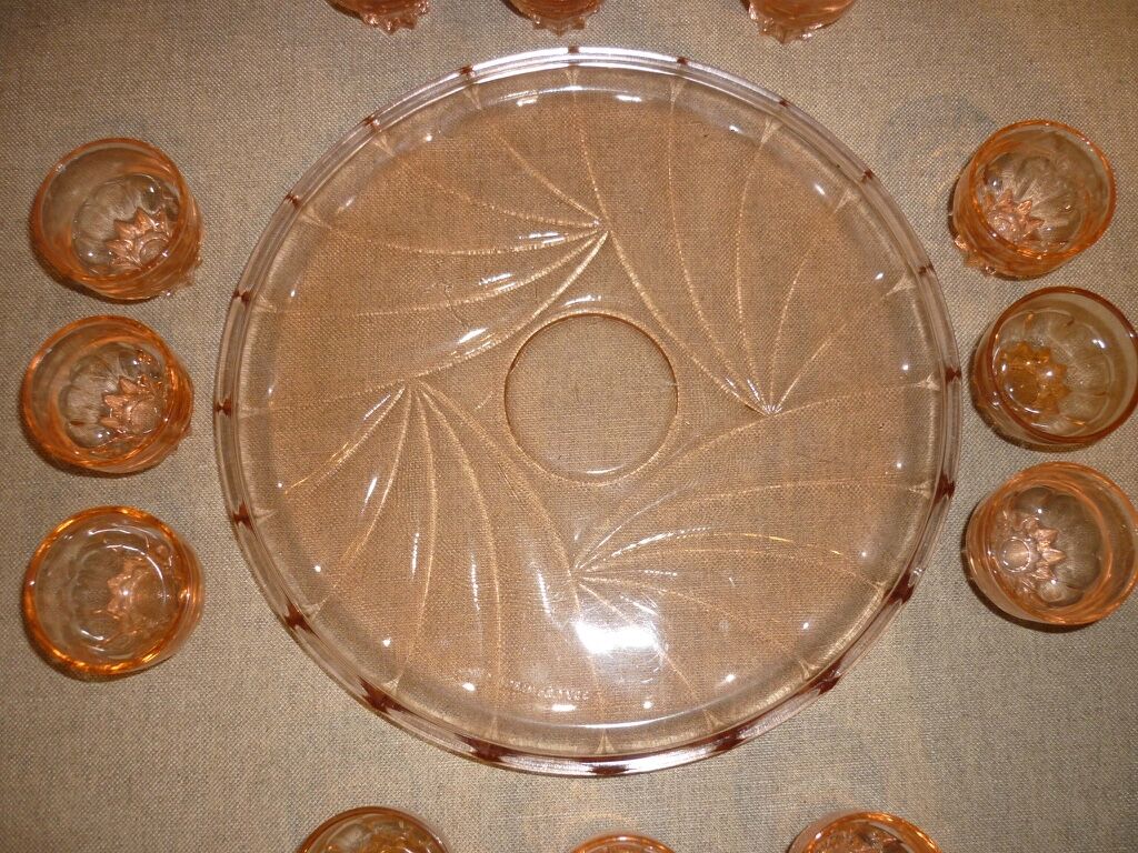 12 shot glasses on pink glass tray