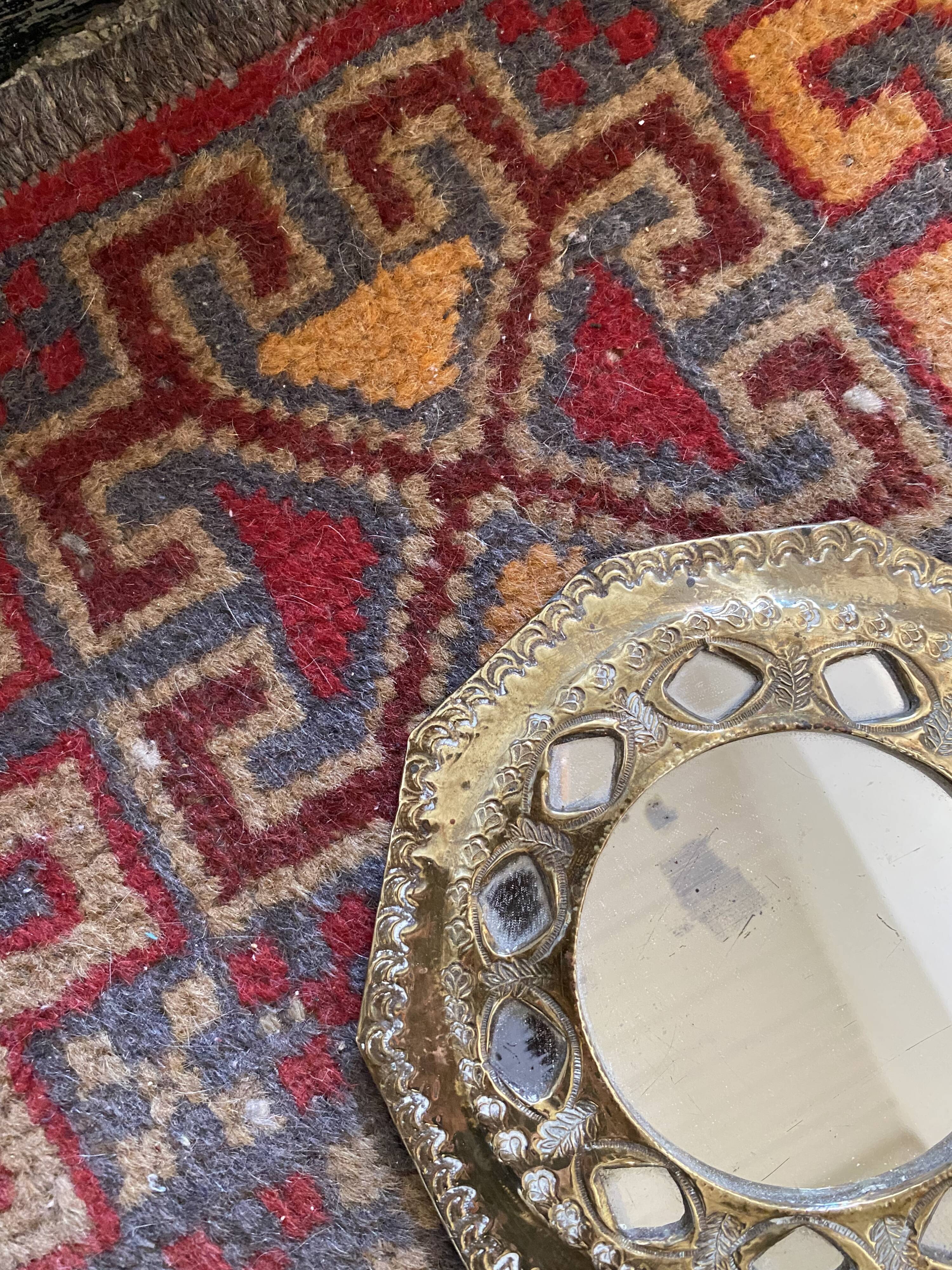 Antique mirror in worked brass