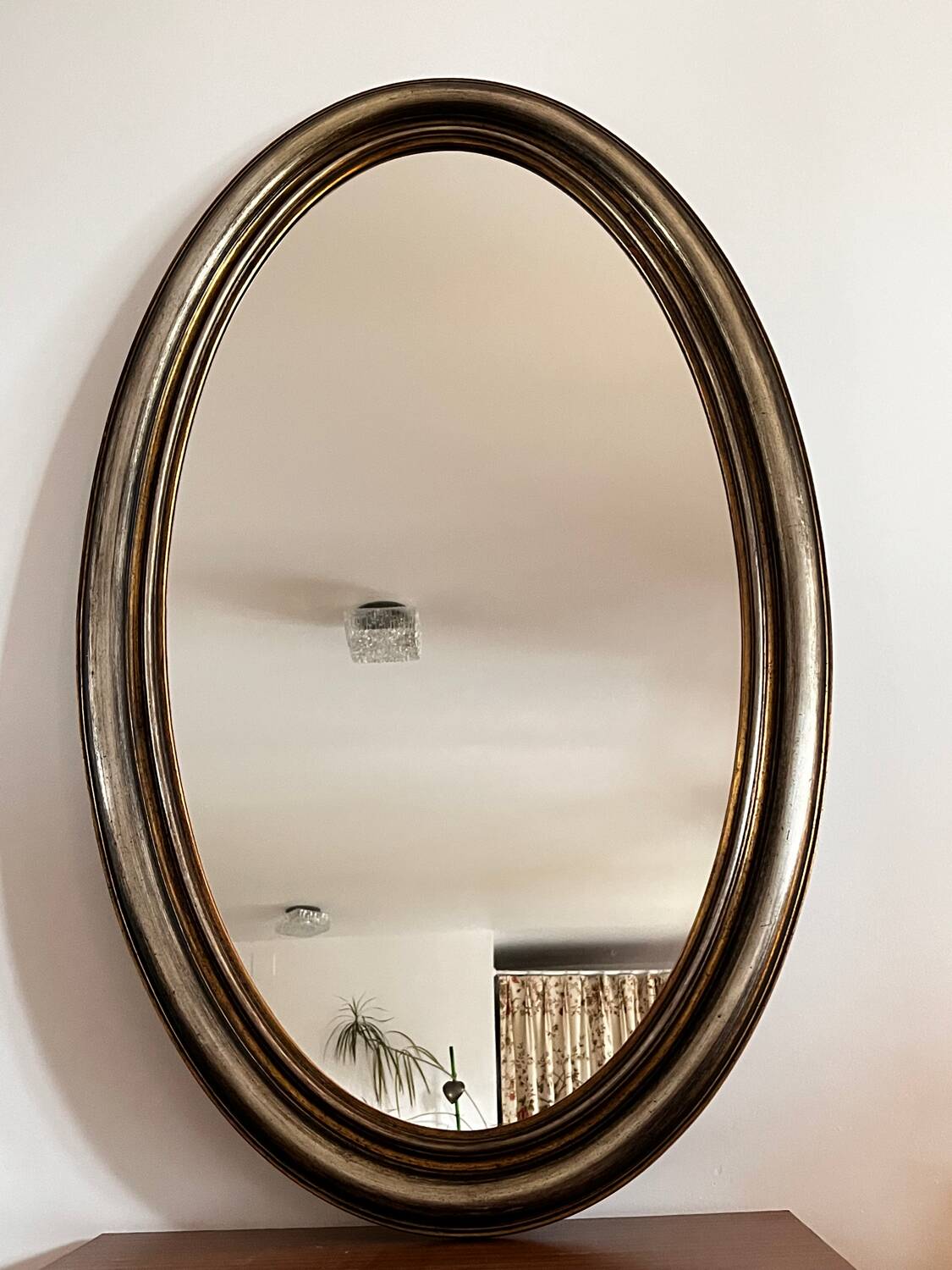 Antique oval mirror made in Belgium.