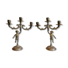 Pair of three-armed cherub-shaped bronze candle holders