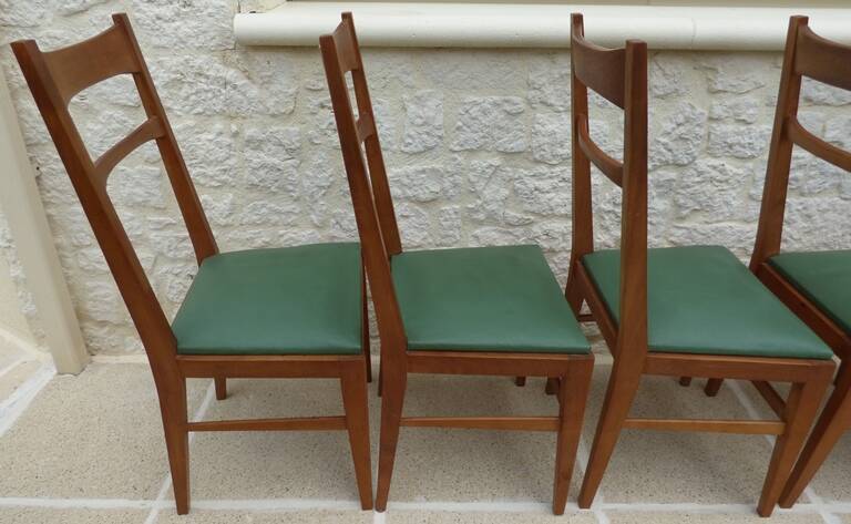 6 modern chairs with banded backs and green faux leather seats