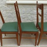 6 modern chairs with banded backs and green faux leather seats