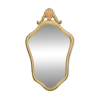 Old beveled wall mirror in solid gilded wood