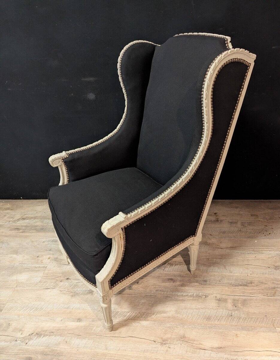 Pair of Louis XVI armchairs with ears in grey painted wood and black fabric.