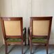 Paire de fauteuils empire en noyer teinté, tissus vert motif de palmette, sculptés têtes de dauphin