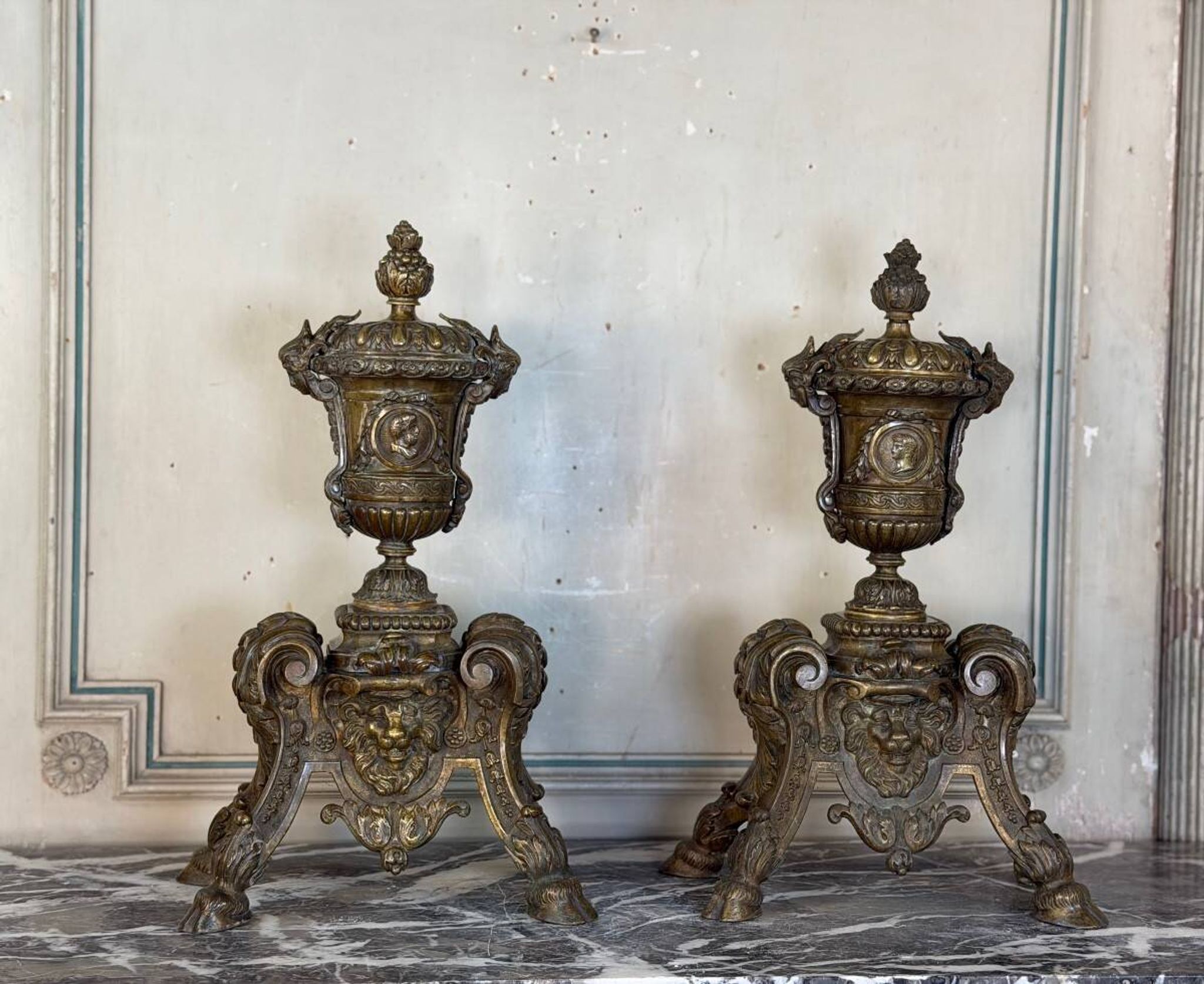 Pair of Louis XIV style andirons in bronze after a design by André-Charles Boulle.