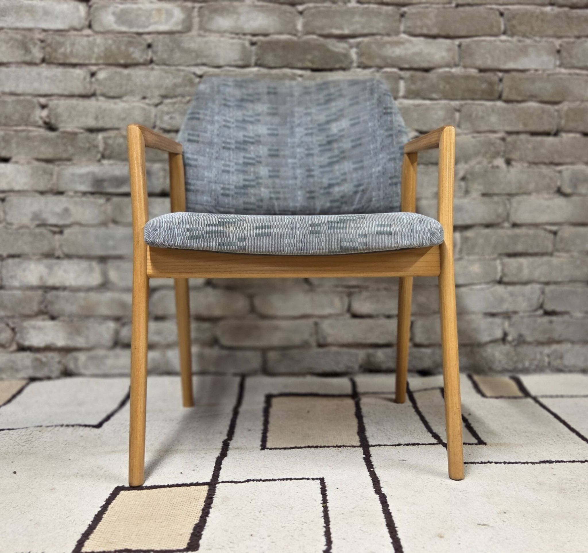 Vintage armchair from the 60s/70s in wood and grey fabric – with armrests.