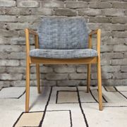 Vintage armchair from the 60s/70s in wood and grey fabric – with armrests.