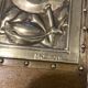 Pair of Art Deco wood and embossed metal landscape frames