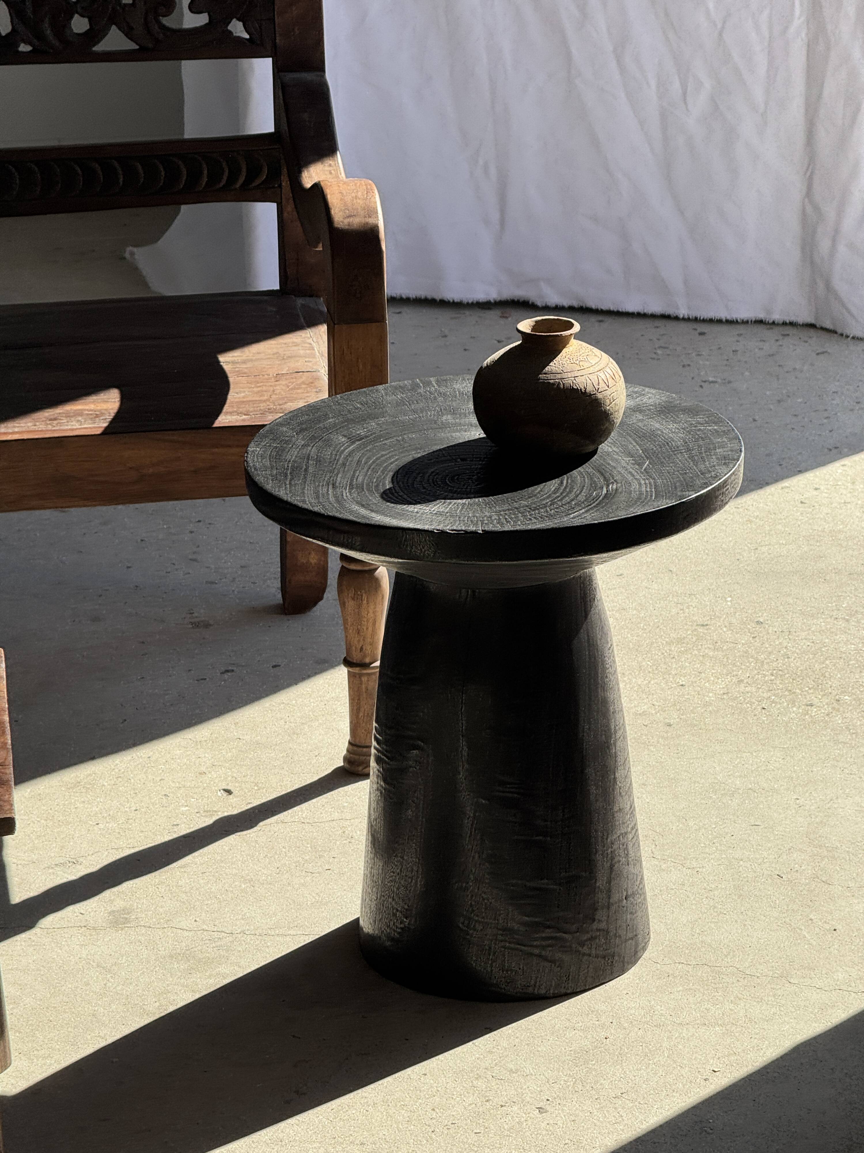 Black solid mango side table (monoxyle) with conical legs