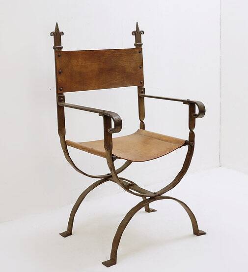 Curule armchair in wrought iron and leather