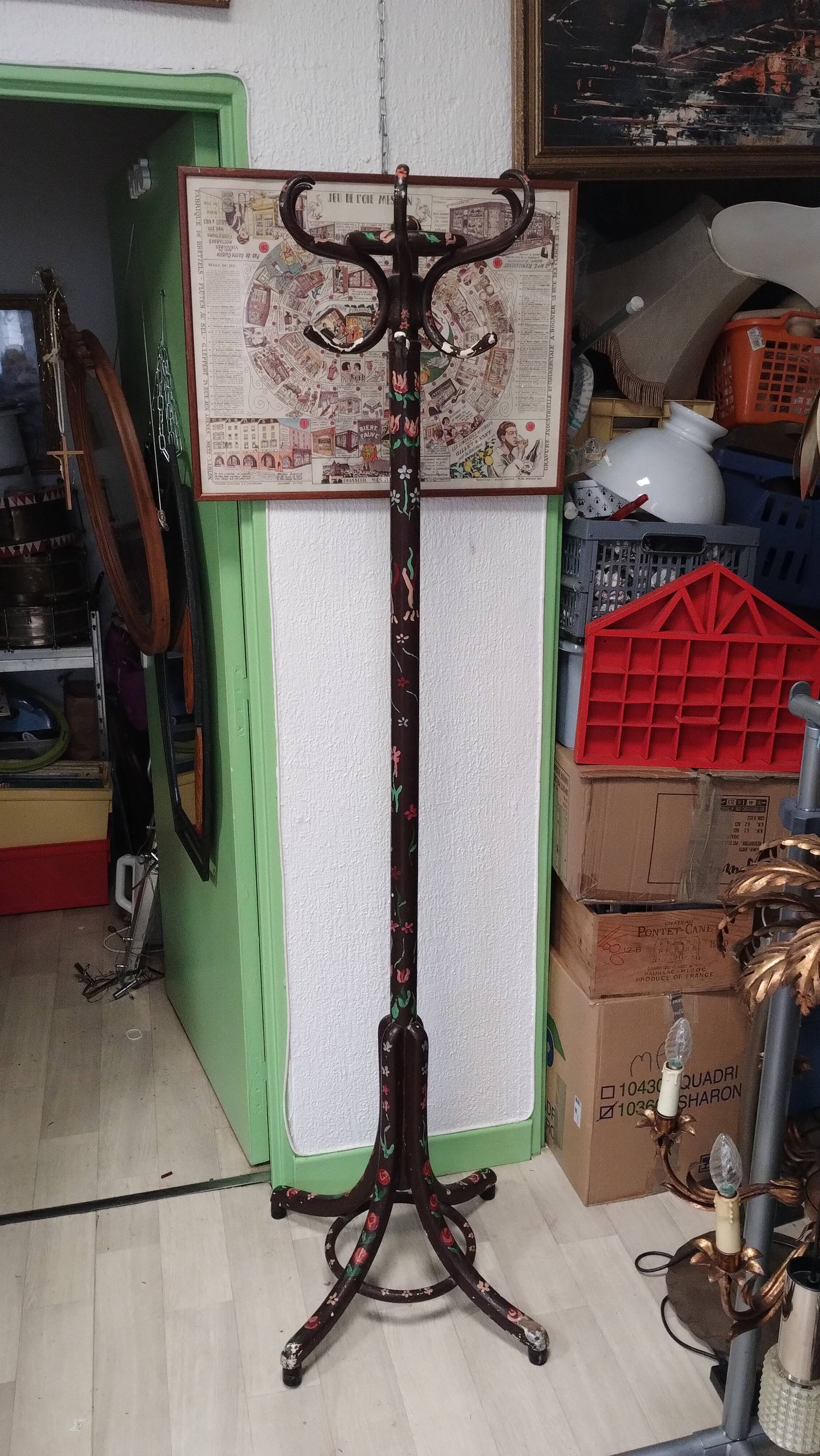 Wooden parrot coat rack with painted floral decoration.