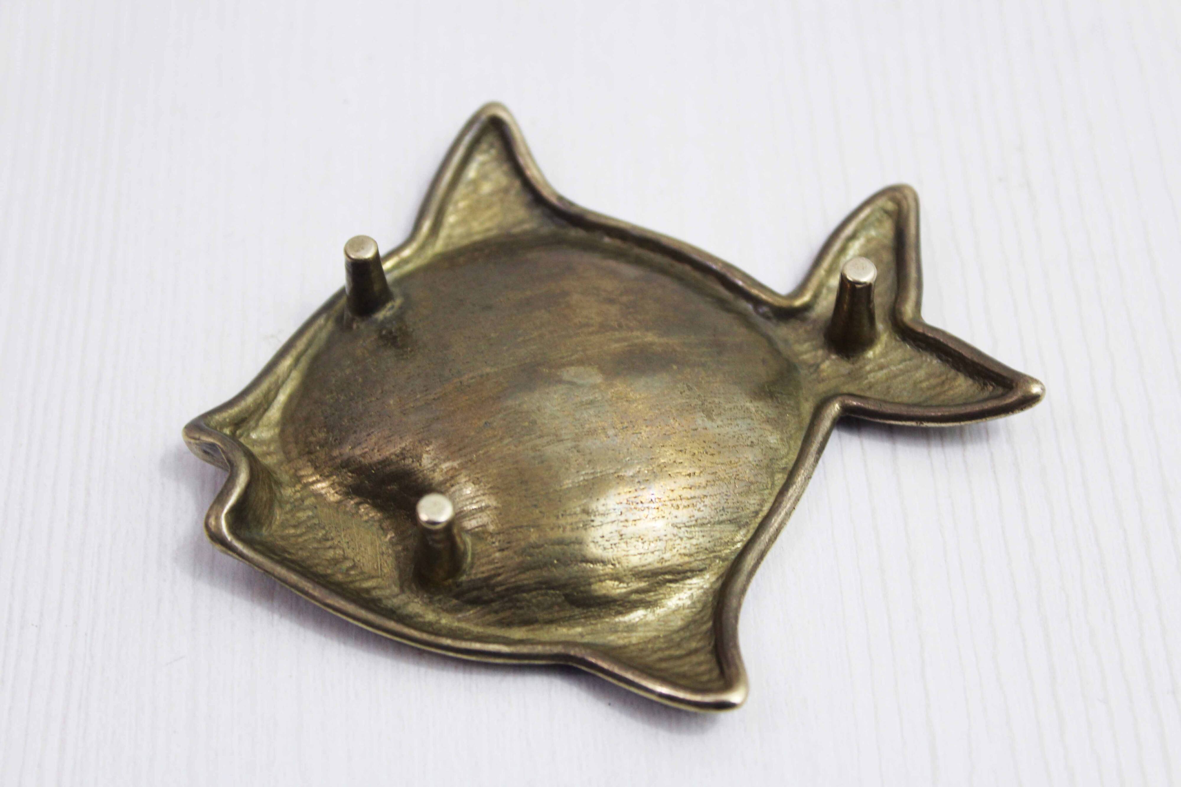 Vintage fish-shaped brass pocket emptier