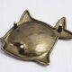 Vintage fish-shaped brass pocket emptier