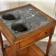Refreshment table in mahogany, grey marble top, two zinc buckets, 18th century.