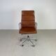 Fauteuil en cuir brun haut dossier soft pad group Eames ICF pour Herman Miller