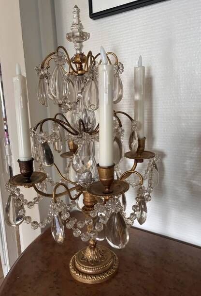 Candle holder or candelabrum with four arms of light.
