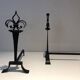 Important pair of wrought iron andirons with torch in heraldic fleur-de-lis design.