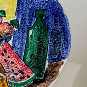 Multicolored hand-painted ceramic wall plate with 1960s Italian fruit motif, signed Stile