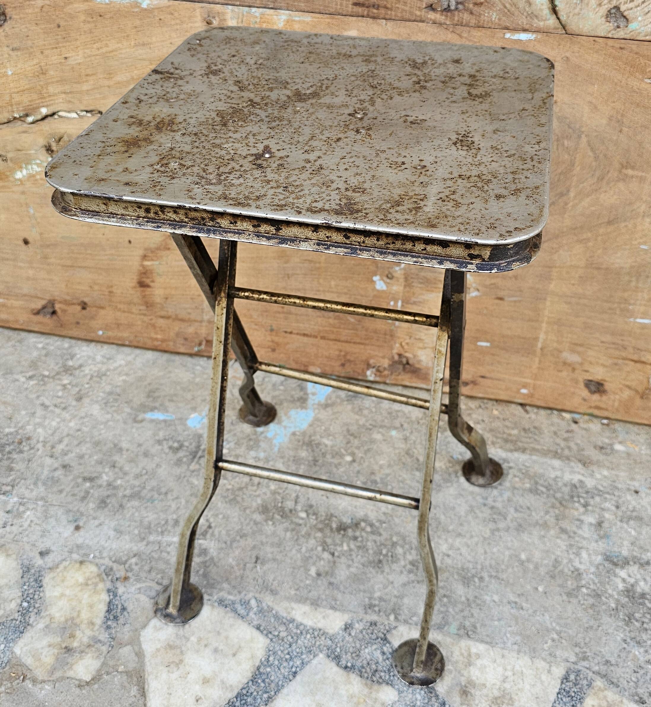 Old industrial folding steel stool