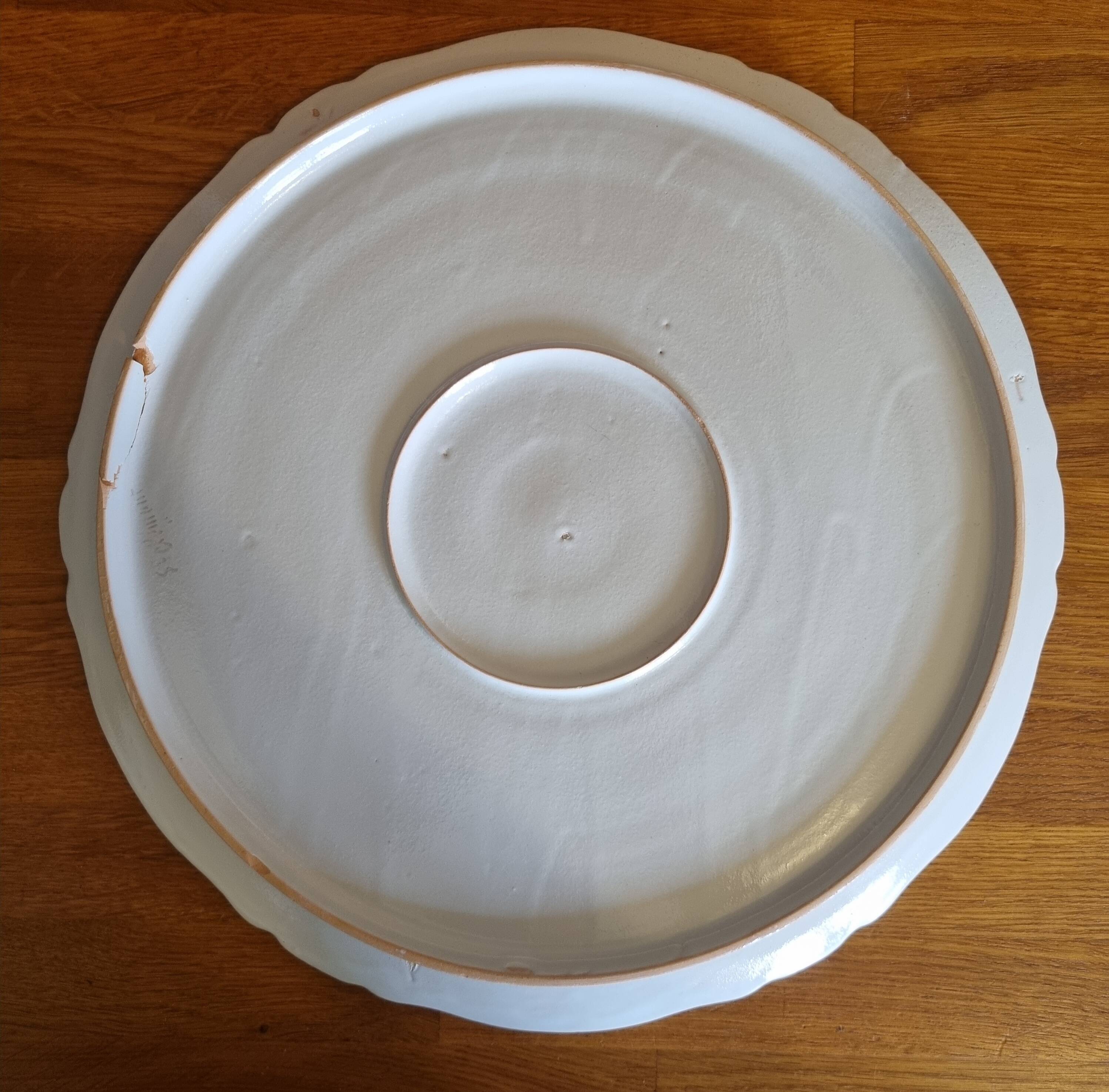 Antique pie dish in St Clément faience with a basket hen motif.