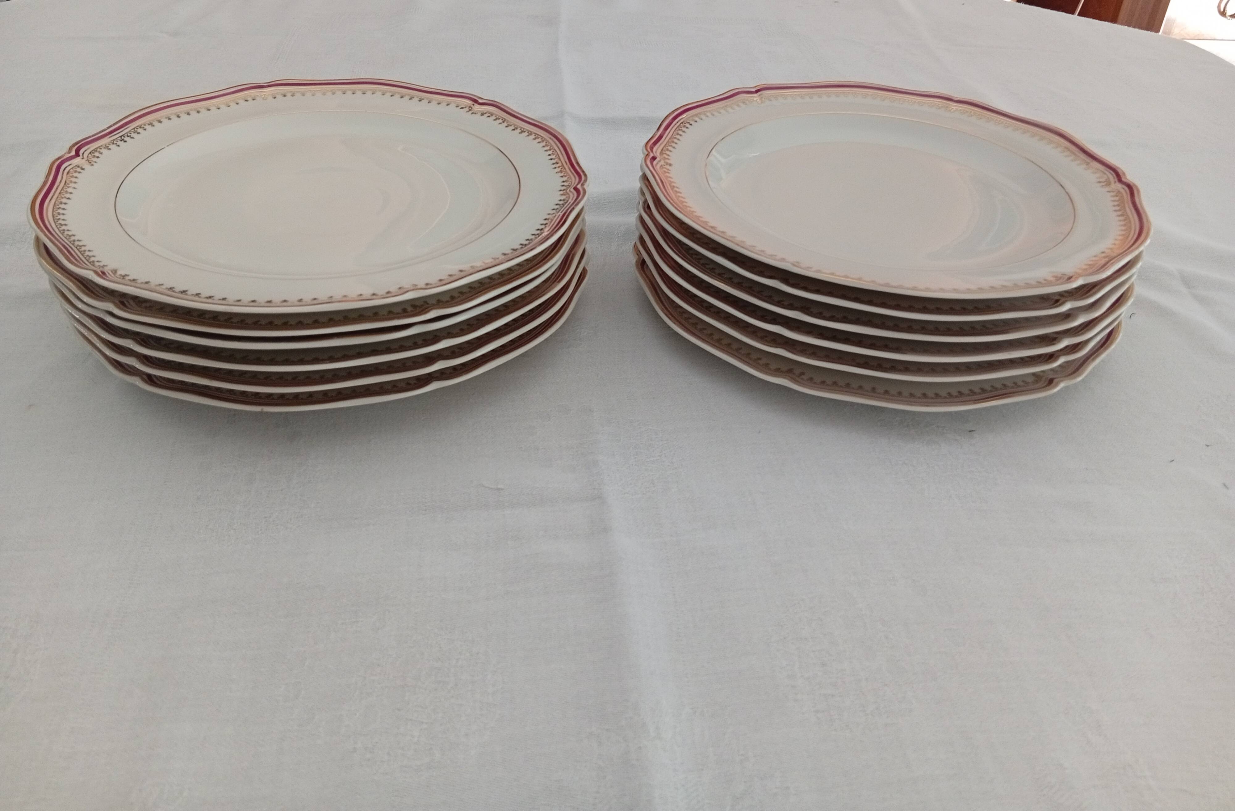 Set of 12 stylised white porcelain dinner plates, signed.