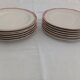 Set of 12 stylised white porcelain dinner plates, signed.
