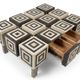 An Art Deco Op Art coffee table made of beech wood with drawers.
