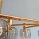 Large designer chandelier in brass and smoked glass globes, 1970s