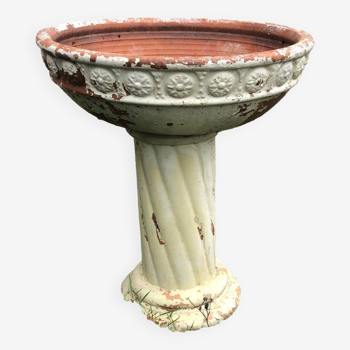 Terracotta planter on patterned column