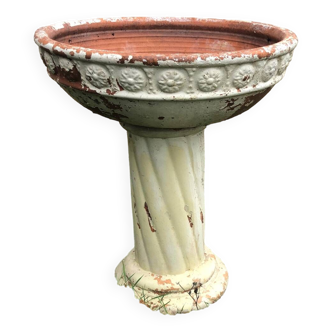 Terracotta planter on patterned column