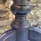Old adjustable piano stool, blackened wood, metal screws, embroidered seat.