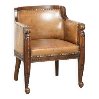 Antique armchair made of sheepskin and wood with decorative nails