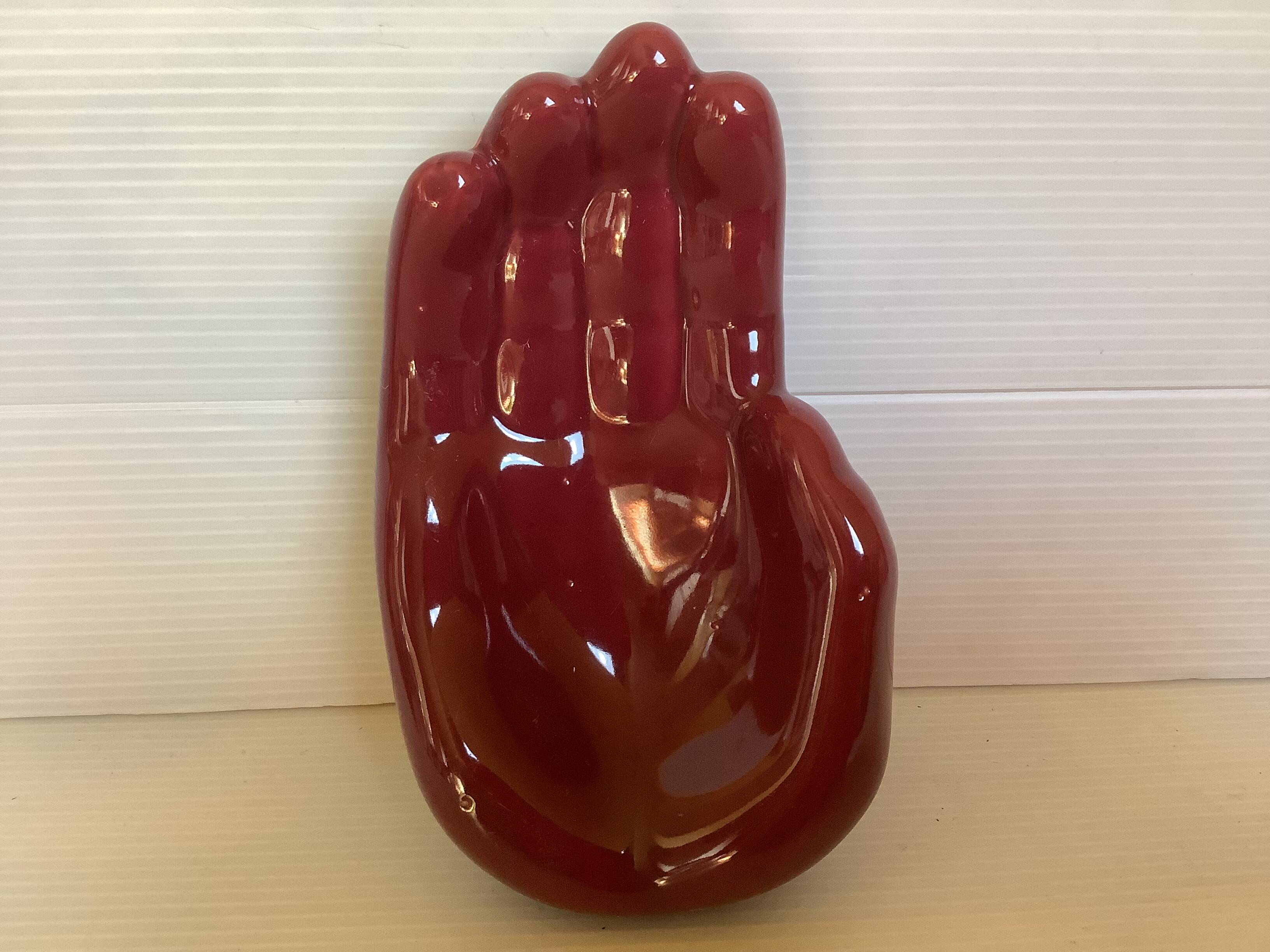 Empty pocket in the shape of a burgundy hand