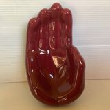 Empty pocket in the shape of a burgundy hand