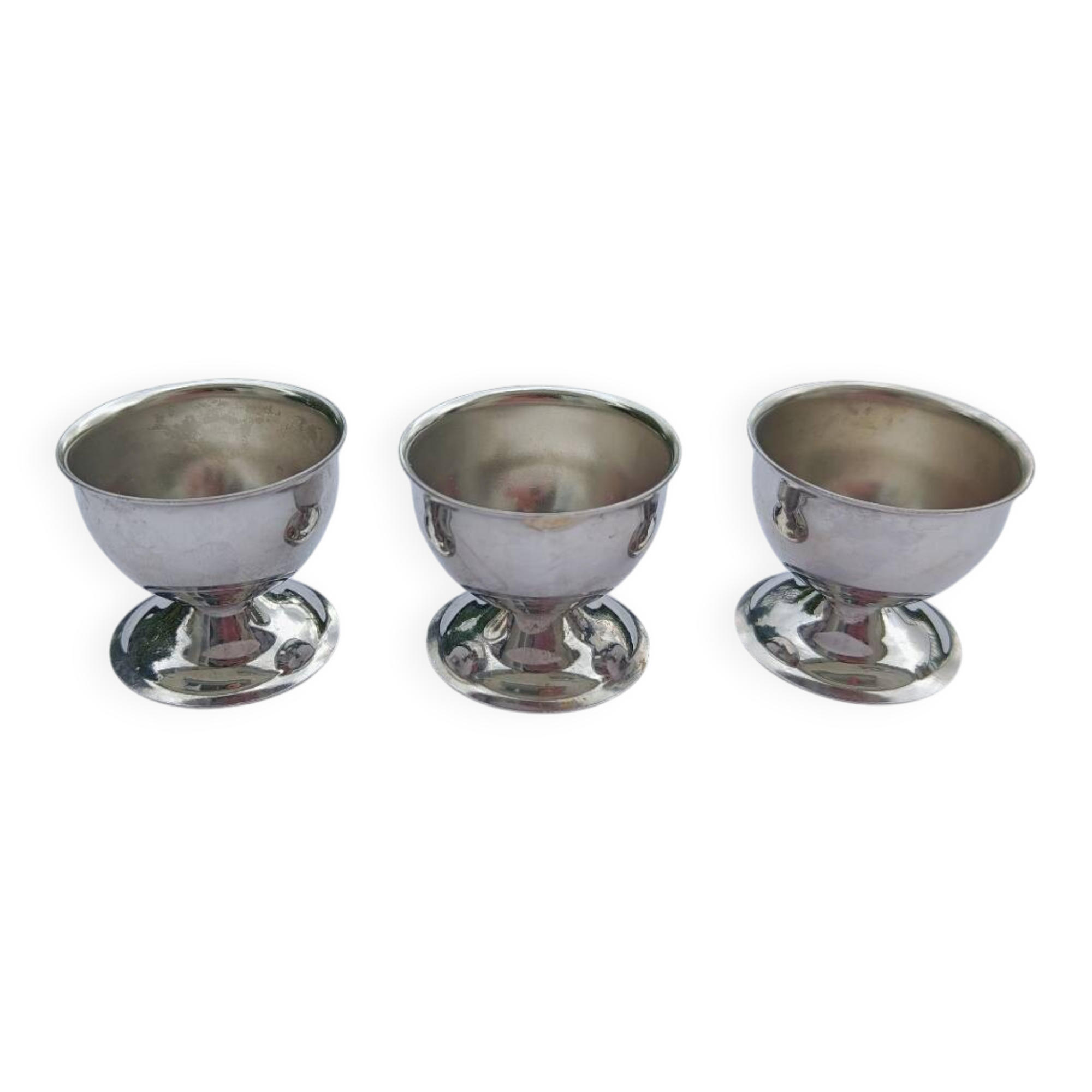 A set of 3 egg cups by Guy Degrenne.