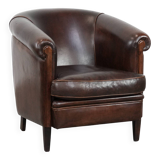 Dark brown vintage club armchair in English style made of sheepskin leather